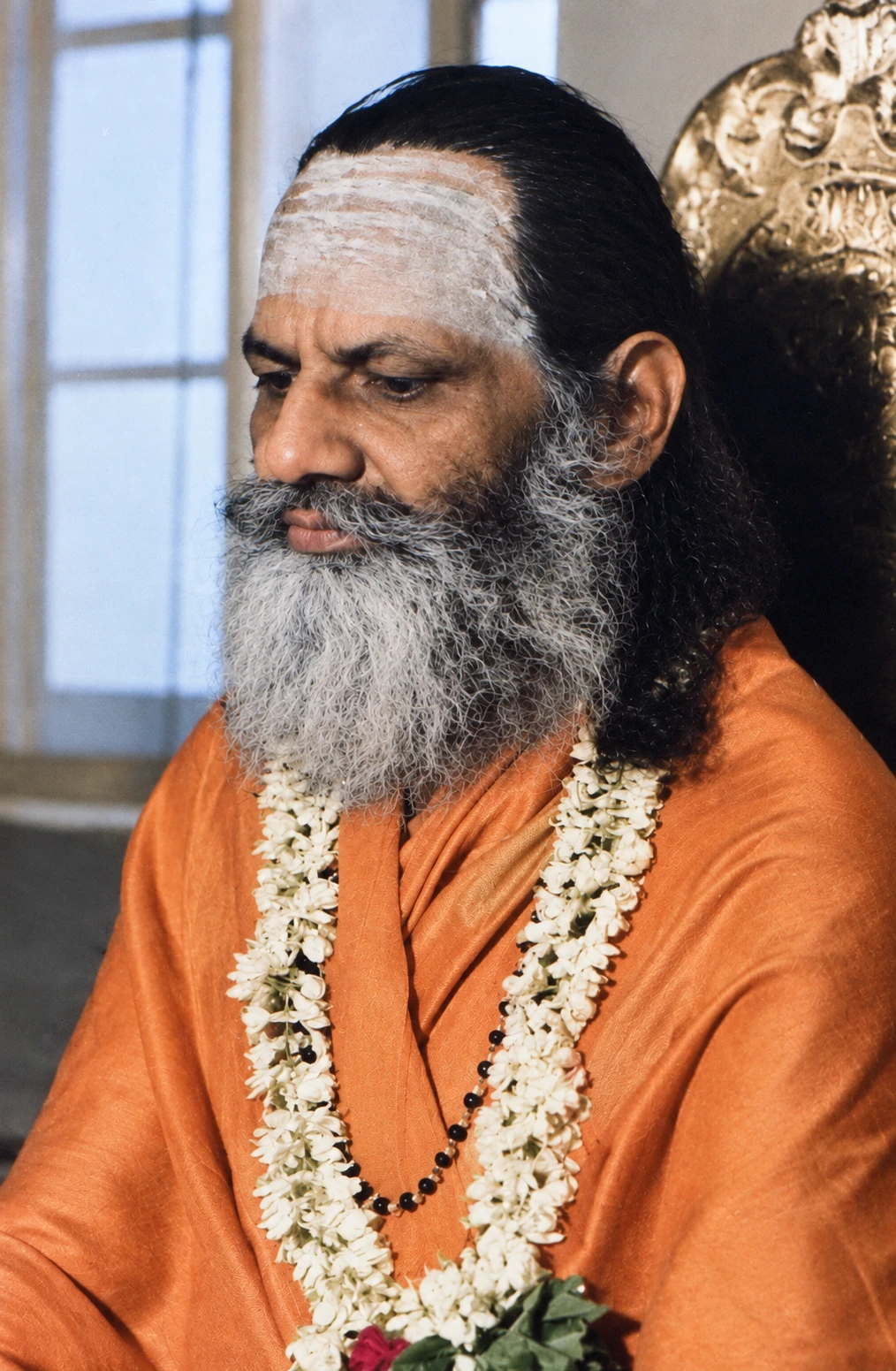 Brahmananda Saraswati in profile, wearing a jasmine garland and sandalwood tilak